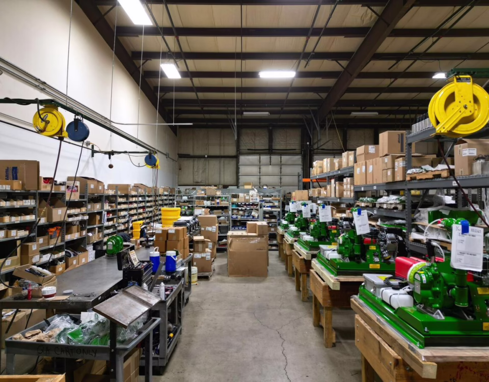 Manufacturing floor showing materials, work-in-progress assemblies, and completed electromechanical products throughout the turnkey assembly process at General Assembly & Manufacturing Corp.
